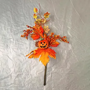 Detailed view of artificial pumpkin with maple leaves berries and pine cone fall decor