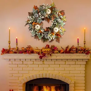 Autumn wreath with pumpkins and maple leaves hanging over a fireplace for fall decor