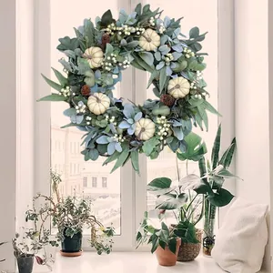 Autumn wreath with white pumpkins, eucalyptus leaves and pine cones for home decor