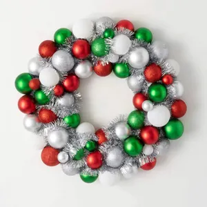 Christmas wreath made of red, green, white, and silver decorative balls on white background