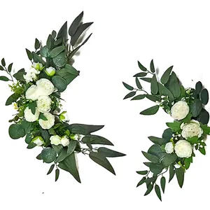 Detail of two-piece faux white roses and eucalyptus leaves for wedding arch decoration