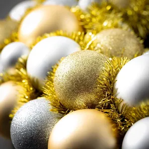 Macro shot of gold and silver Christmas ornaments with glitter and matte finishes
