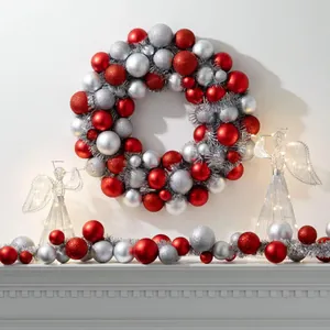 Detail of a red and silver Christmas wreath and garland set with textured ornaments