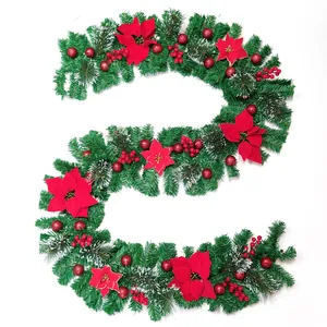Close-up of a 2.7m Christmas garland with red poinsettias and white snow-dusted pine needles