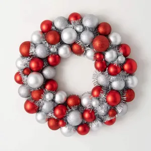 Classic red and silver Christmas wreath with matte and glitter baubles for festive decor