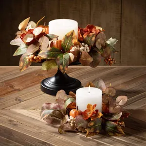 Détail de couronnes de bougies automnales avec feuilles d'érable et citrouilles