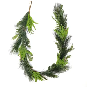 Close-up of Christmas greenery garland with pine needles, cedar leaves and gold beads