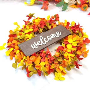 Autumn welcome wreath with orange leaves and pumpkins for harvest festival door decor