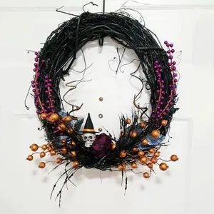 Halloween wreath with purple berries, white skull in witch hat, and black twigs for door decor