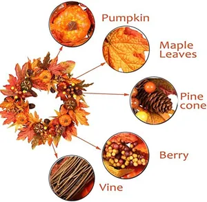 Detail view of pumpkin, maple leaves, and pine cones on the autumn wreath vine base