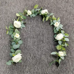 Detail of artificial eucalyptus garland with white silk roses for wedding arch decor