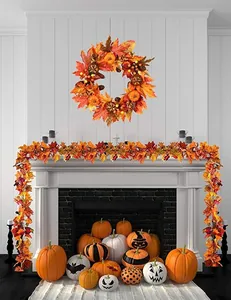 Close-up of fall wreath and garland with realistic maple leaves, pumpkins and pine cones
