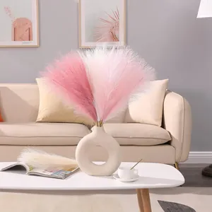 Faux pampas grass in pink and cream with a modern hollow ceramic vase for home decor
