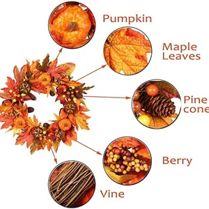 Fall wreath with pumpkins, maple leaves, and pine cones on a natural vine base