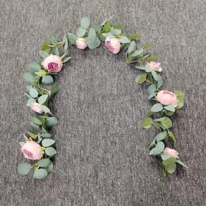 Detail view of pink artificial peony and eucalyptus garland for wedding arch decor