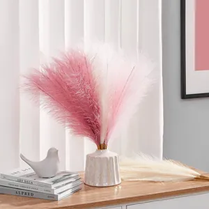 Artificial pampas grass in pink and white plumes with textured ceramic vase decor