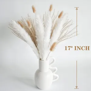 Detail showing 17-inch height of pampas grass bouquet in white wavy handle ceramic vase