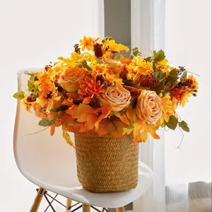 Autumn decoration bouquet with maple leaves, pine cones and roses in a straw basket