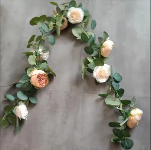 Detailed texture of silk peony and rose flower garland with eucalyptus green leaves