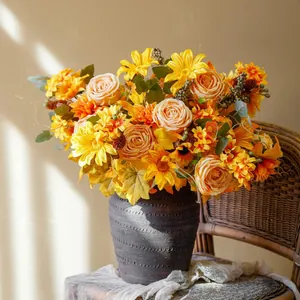 Autumn artificial flower arrangement with sunflowers and roses in a vintage clay pot
