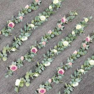 Detail view of artificial rose and eucalyptus garlands with pink and white silk petals