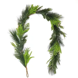 Artificial Christmas garland with green pine needles and golden berries on white background
