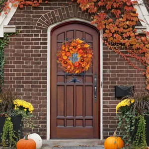 Detailed harvest wreath with sunflowers and pumpkins hanging on a rustic wooden door