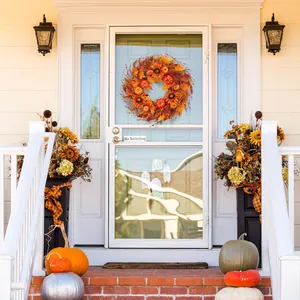 Detail of autumn wreath with sunflowers and pumpkins on a white American front door