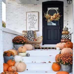 Detail of farmhouse autumn wreath with white wood beads, pumpkins, and maple leaves
