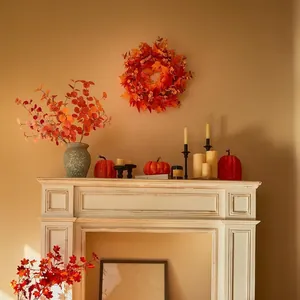 Autumn maple leaf wreath and pumpkin decor set displayed on a white fireplace mantle