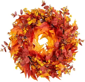 Detail of autumn wreath with maple leaves and eucalyptus for Thanksgiving home decor