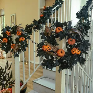 Halloween wreath with black maple leaves and orange pumpkins on a white staircase railing