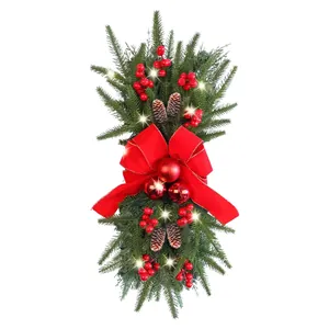 Pre-lit Christmas teardrop swag with red berries, pine cones and a large red bow
