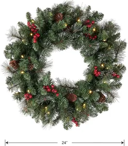 Detail of 24-inch Christmas wreath with pine needles, red berries, cones and warm LED lights