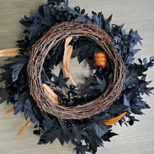 Close-up of Halloween wreath with black maple leaves and orange glitter pumpkin on twigs