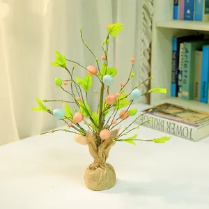 Detailed view of Easter decorative tree with colored foam eggs and rustic burlap base