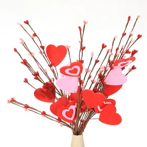 Close-up of artificial Valentine branch with red heart berries and pink foam hearts