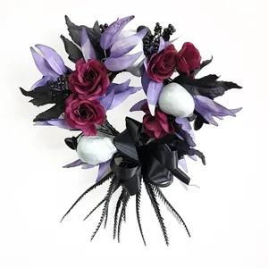 Halloween wreath with red roses, purple leaves, and black satin bow on white background