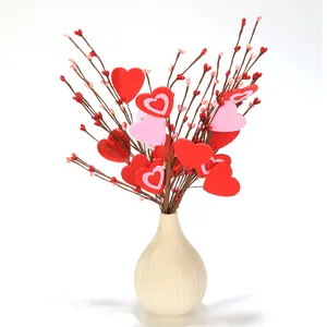 Close-up of decorative artificial heart berry stems in a textured ceramic vase