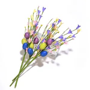Detail of Easter artificial stems with speckled eggs and colorful wildflowers decoration