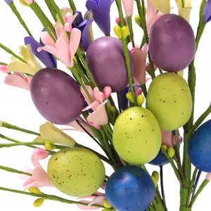 Macro detail of Easter decorative stems with colorful speckled eggs and blooming buds