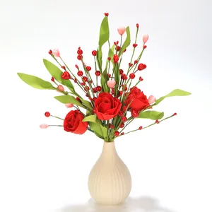 Detailed view of red silk roses with berries and heart decor in a ceramic vase
