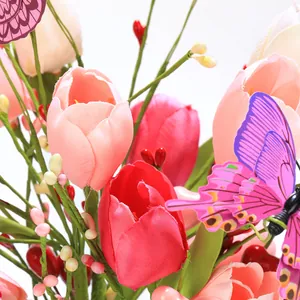 Close-up of artificial tulips with butterfly decor and realistic pink silk petals