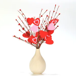 Artificial heart berry branches in white ceramic vase for Valentine's Day decor