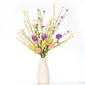 Artificial Easter floral stem with colorful spotted eggs and bellflowers in a vase