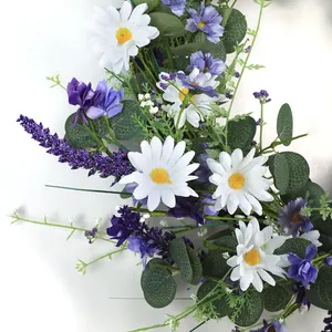 Detail of faux white daisies and purple lavender with green eucalyptus leaves on white background