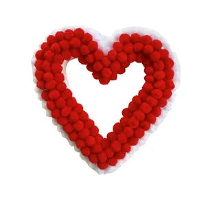Handmade red and white heart-shaped pompom wreath for romantic home wall decoration