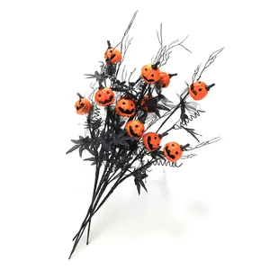 Halloween decorative branch with orange jack-o-lantern pumpkins and black maple leaves
