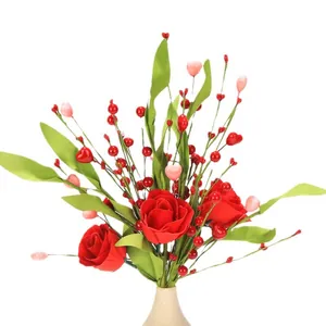 Artificial red rose bouquet with heart berries and green leaves in a ceramic vase