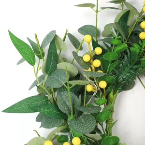 Detail of eucalyptus leaf wreath with yellow berries and integrated LED fairy lights